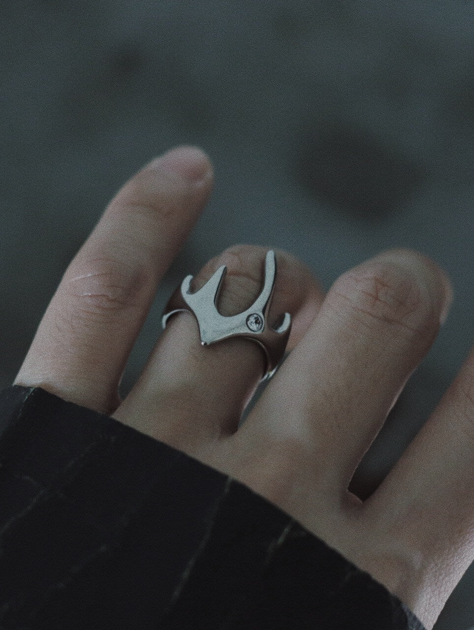 Close-up of the Liquid Flame statement ring on a finger, sculptural wide band silver ring, adjustable artistic jewelry for modern streetwear.