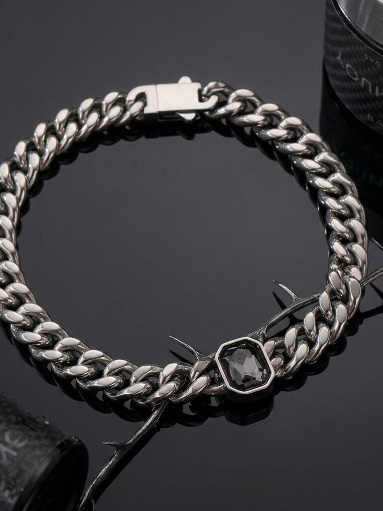 Emerald-cut grey gemstone on 316L stainless steel Cuban link bracelet, industrial aesthetic jewelry by Monora Studio.
