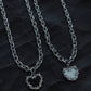 White and black enamel thorn heart necklaces, high-polish stainless steel liquid metal collection by Monora Studio.