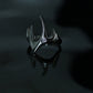 Tarnish-proof silver flowing flame ring on a dark reflective surface, high-shine industrial aesthetic jewelry, durable surgical steel.