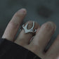 Close-up of the Liquid Flame statement ring on a finger, sculptural wide band silver ring, adjustable artistic jewelry for modern streetwear.