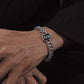 Model wearing grey zircon Cuban link bracelet, modern masculine streetwear fashion, waterproof stainless steel wristwear.