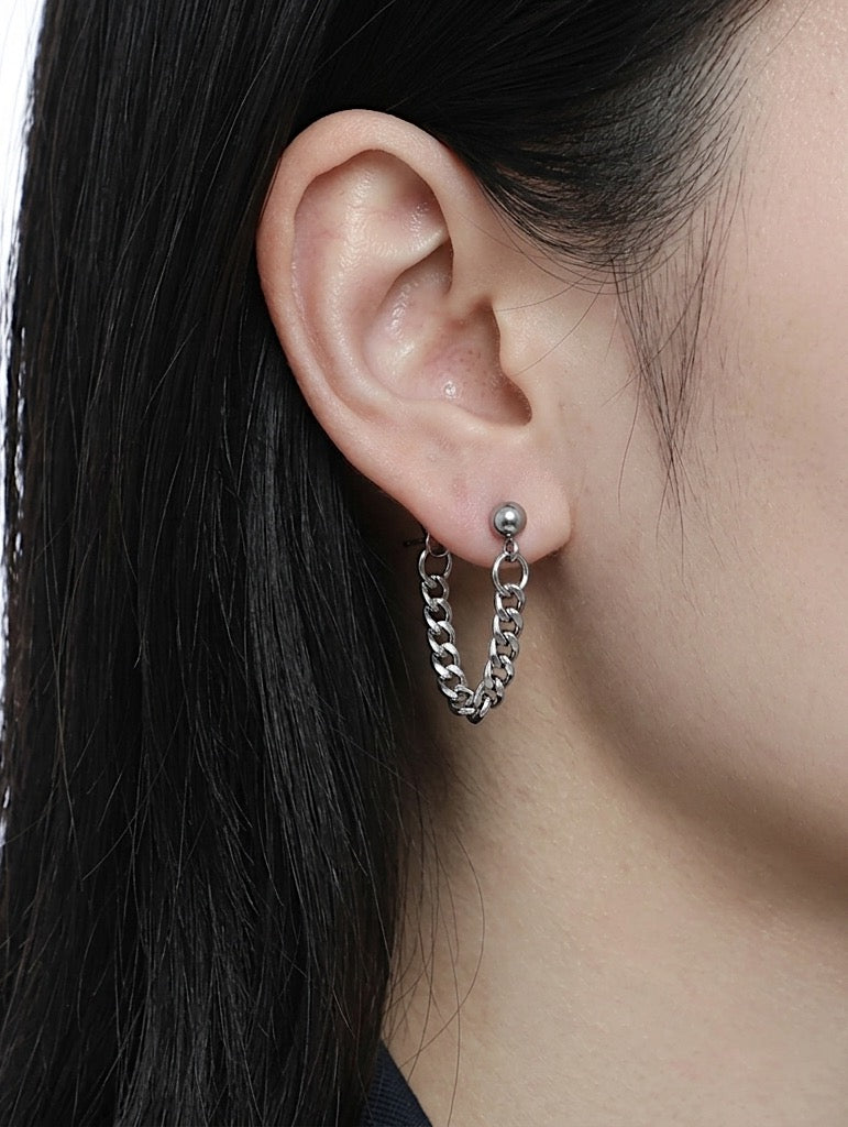 Model wearing a draped curb chain earring, soft grunge aesthetic ear stack, hypoallergenic stainless steel jewelry for sensitive ears.