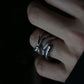 Moody lifestyle shot of a tarnish-proof stainless steel knot ring, aesthetic silver adjustable ring for stacking, durable fashion jewelry for daily wear.