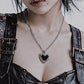 Model wearing gothic thorn heart necklace, Y2K grunge streetwear style, durable stainless steel jewelry for darkwear.