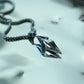 Monora Studio stainless steel spearhead pendant reflection on a metallic water surface close up shot⁠