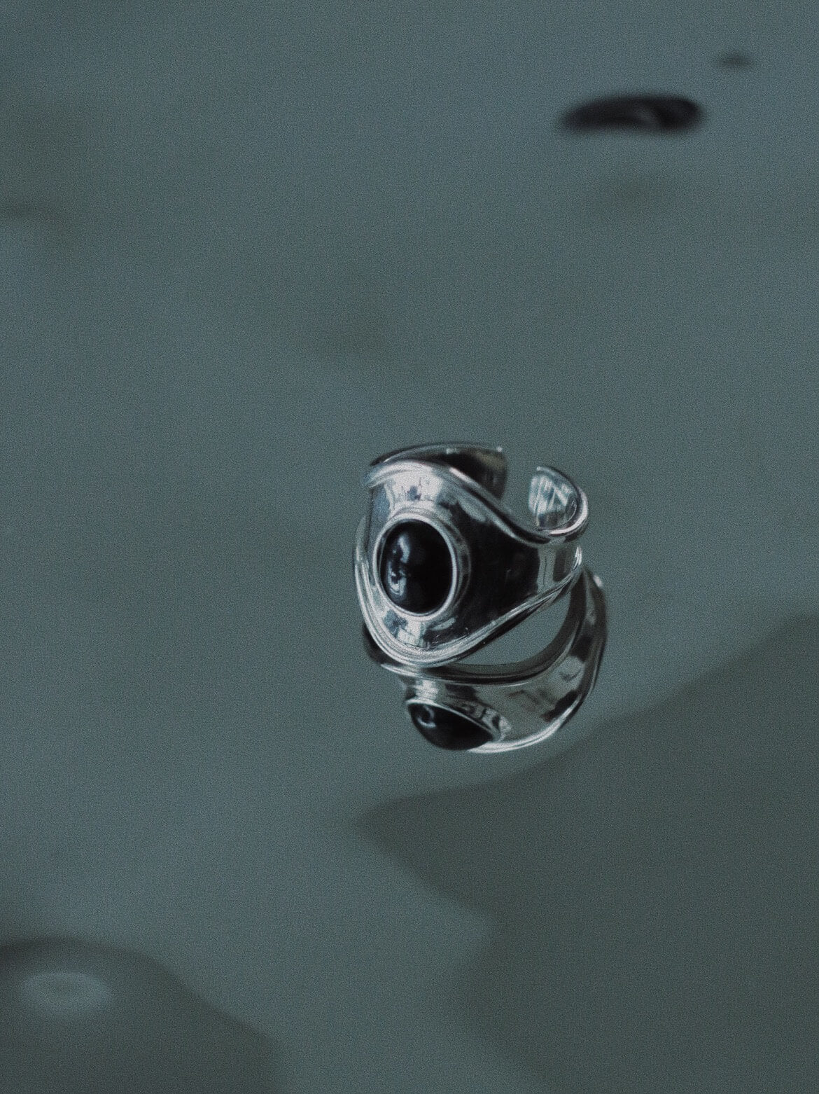 molten silver rings stacked, showcasing unique artisanal textures and edgy avant-garde jewelry design.