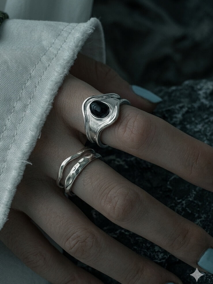 Handcrafted 925 sterling silver ring with molten lava texture on finger, organic gothic style streetwear jewelry by Monora Studio.