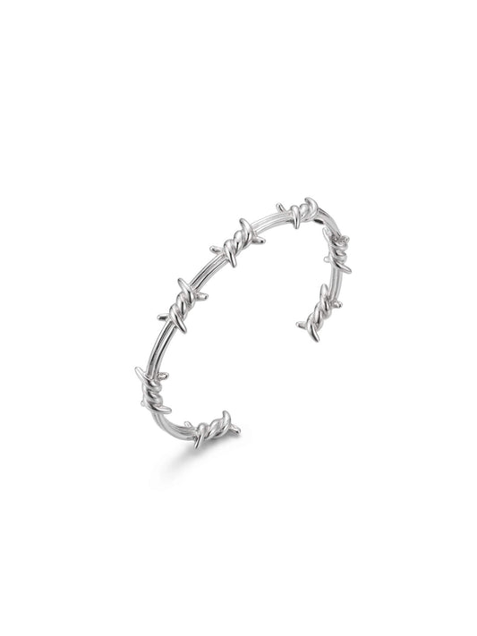 Professional product studio shot of Monora Studio geometric silver wire thorn bracelet on pure white background⁠